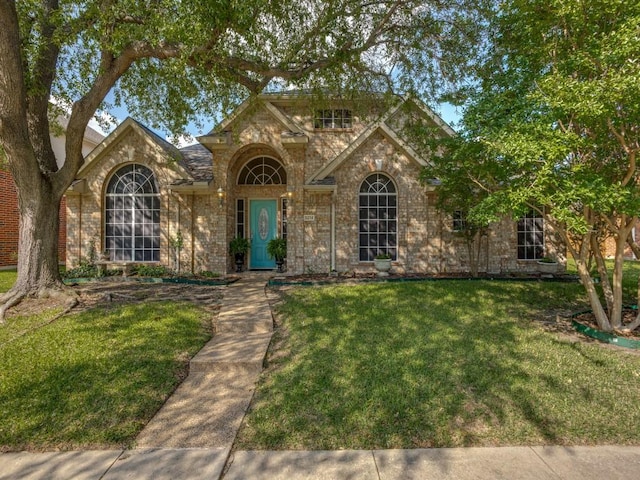 3214 Pecan Meadow Dr, Garland, TX 75040 - traditional-style home with a front lawn, stone siding, and brick siding