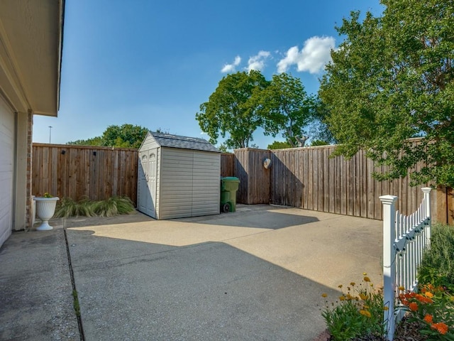 3214 Pecan Meadow Dr, Garland, TX 75040 - view of patio / terrace featuring a shed, an outdoor structure, and a fenced backyard