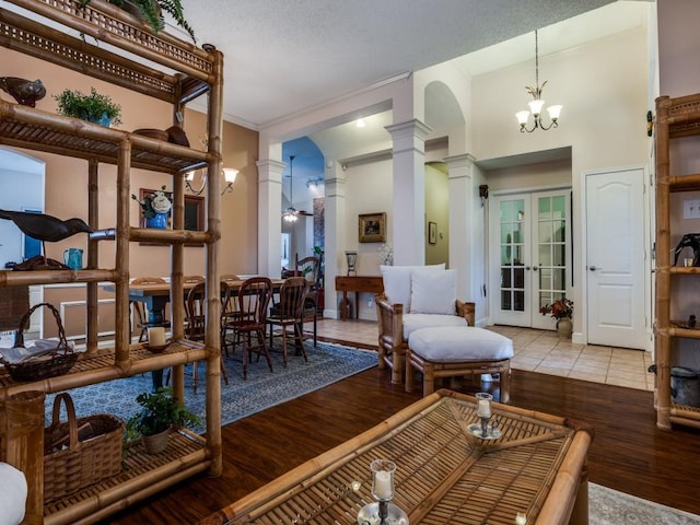 3214 Pecan Meadow Dr, Garland, TX 75040 - living area featuring ornate columns, wood finished floors, a chandelier, baseboards, and ornamental molding