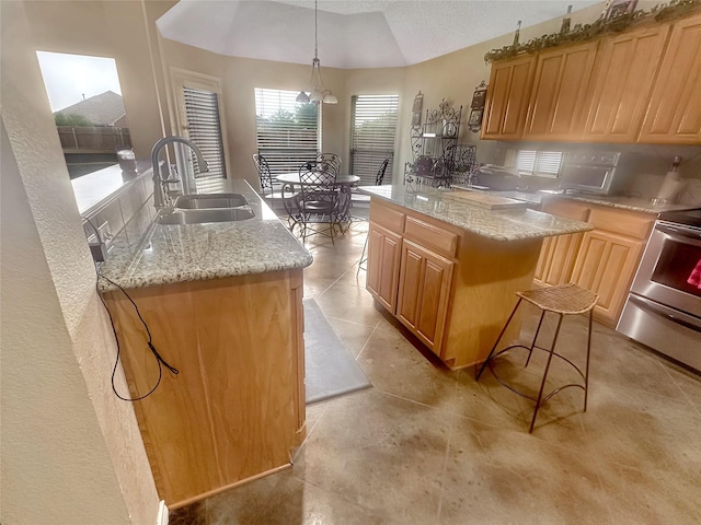 10717 Greenview Ct, Benbrook, TX 76126 - kitchen featuring a sink, stove, a center island, light brown cabinetry, and light stone countertops