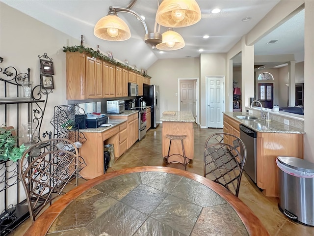 10717 Greenview Ct, Benbrook, TX 76126 - kitchen with stainless steel appliances, a sink, a center island, light stone countertops, and vaulted ceiling