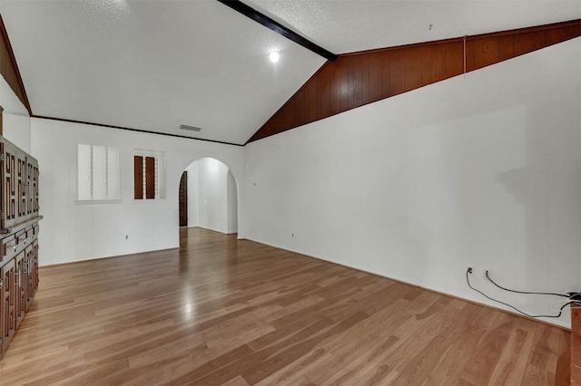 1717 Melrose St, Garland, TX 75042 - unfurnished living room featuring arched walkways and light wood-style floors