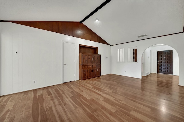 1717 Melrose St, Garland, TX 75042 - unfurnished living room featuring arched walkways and wood finished floors