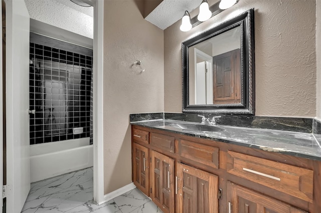 1717 Melrose St, Garland, TX 75042 - full bathroom with a textured wall, marble finish flooring, vanity, baseboards, and shower / washtub combination