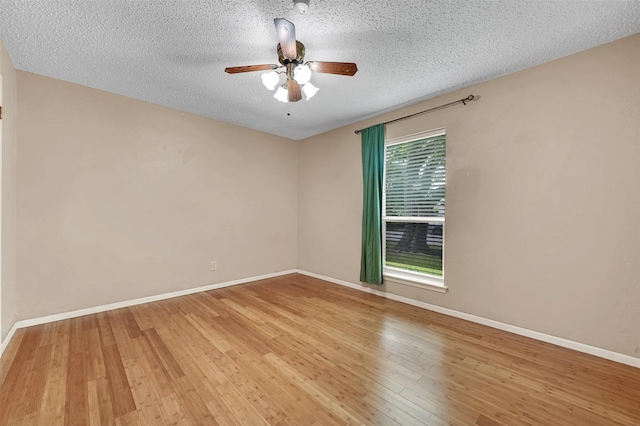 1717 Melrose St, Garland, TX 75042 - spare room featuring a ceiling fan, wood finished floors, a textured ceiling, and baseboards