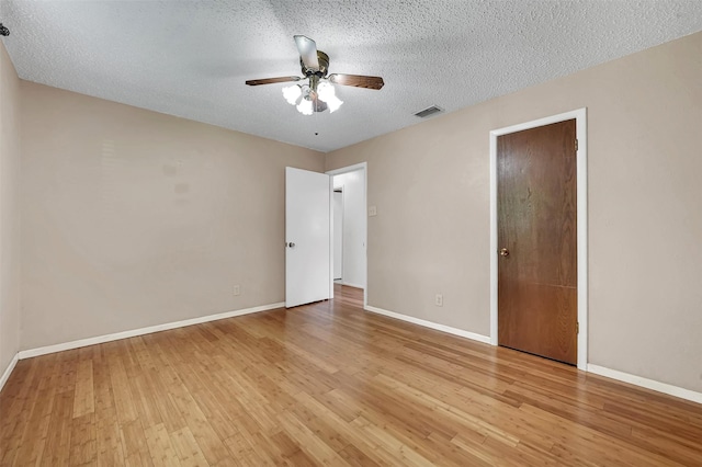 1717 Melrose St, Garland, TX 75042 - unfurnished bedroom with baseboards, light wood-style floors, a textured ceiling, and a ceiling fan