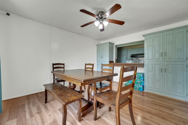 1717 Melrose St, Garland, TX 75042 - dining area with ceiling fan, light wood-type flooring, and a textured ceiling