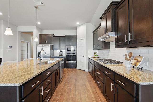 2172 Knightsgate Rd, Argyle, TX 76226 - kitchen featuring appliances with stainless steel finishes, a sink, under cabinet range hood, recessed lighting, and dark brown cabinetry