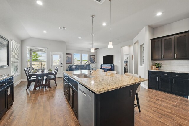 2172 Knightsgate Rd, Argyle, TX 76226 - kitchen featuring a sink, stainless steel dishwasher, wood finished floors, open floor plan, and recessed lighting