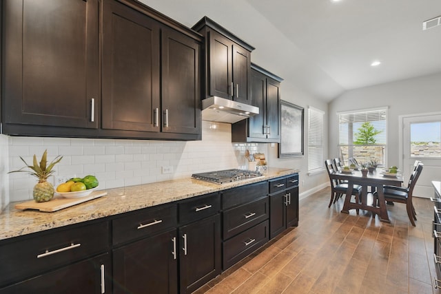 2172 Knightsgate Rd, Argyle, TX 76226 - kitchen featuring stainless steel gas cooktop, baseboards, lofted ceiling, wood finished floors, and light stone countertops