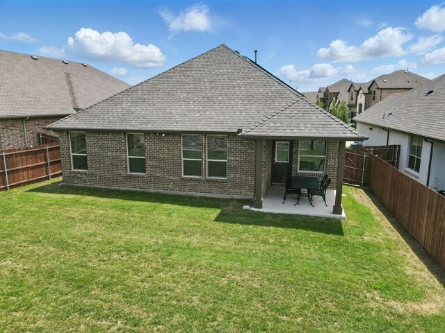 2172 Knightsgate Rd, Argyle, TX 76226 - back of house featuring a shingled roof, brick siding, and a patio