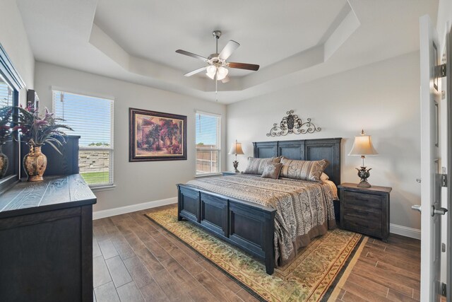 2172 Knightsgate Rd, Argyle, TX 76226 - bedroom with a tray ceiling, baseboards, dark wood-type flooring, and a ceiling fan