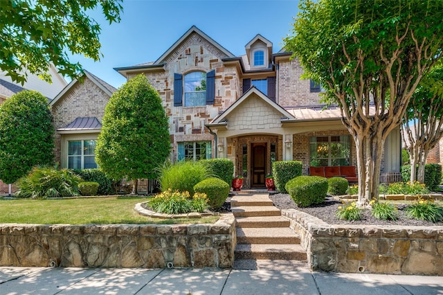 13348 Torrington Dr, Frisco, TX 75035 - view of front of house featuring brick siding, a front yard, stone siding, and a standing seam roof