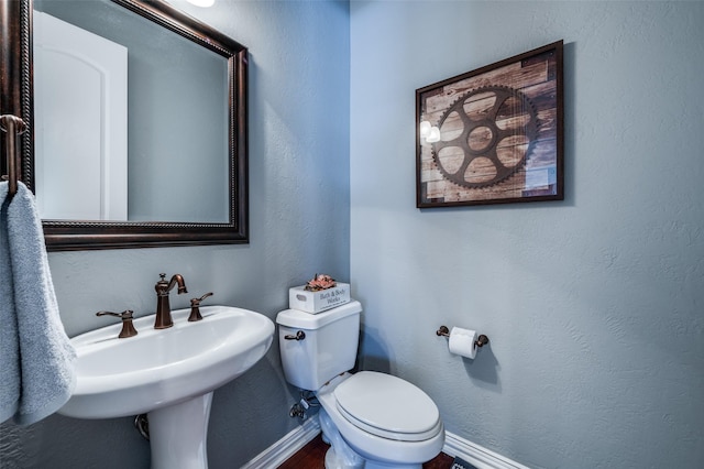 13348 Torrington Dr, Frisco, TX 75035 - half bathroom featuring toilet, baseboards, and a sink