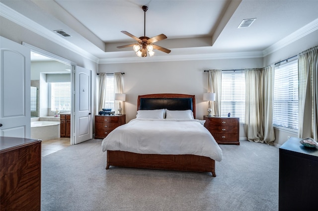 13348 Torrington Dr, Frisco, TX 75035 - bedroom featuring light colored carpet, a tray ceiling, ornamental molding, a ceiling fan, and connected bathroom