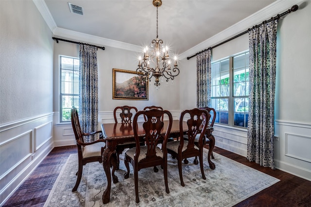 13348 Torrington Dr, Frisco, TX 75035 - dining room featuring wood finished floors, crown molding, a chandelier, a wainscoted wall, and a decorative wall