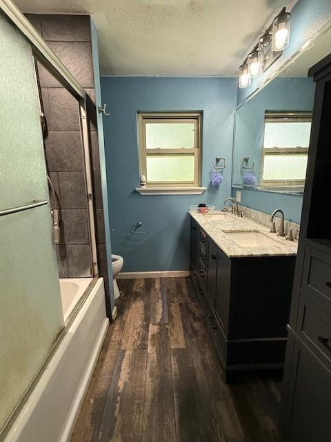 3524 Paramount St, North Richland Hills, TX 76117 - bathroom featuring wood finished floors, toilet, healthy amount of natural light, and double vanity
