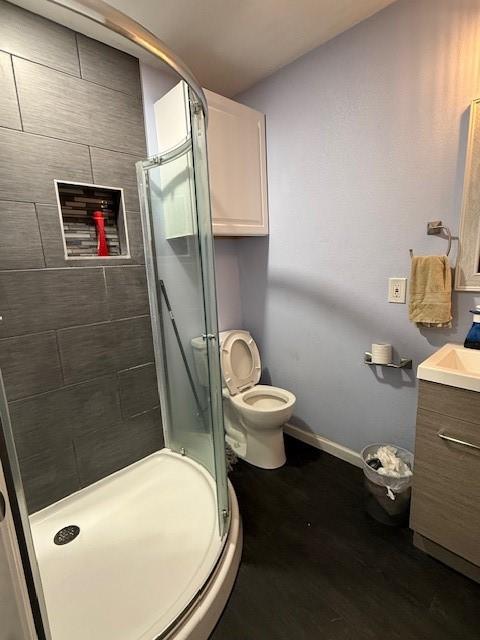 3524 Paramount St, North Richland Hills, TX 76117 - bathroom with a stall shower, vanity, toilet, and baseboards