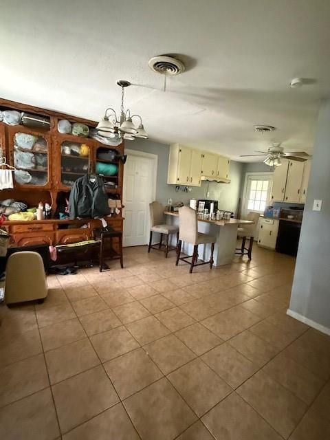 3524 Paramount St, North Richland Hills, TX 76117 - tiled dining area with a chandelier, a ceiling fan, and baseboards