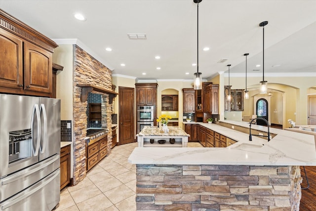1085 Forest Bend Ct, Cross Roads, TX 76227 - kitchen with appliances with stainless steel finishes, crown molding, arched walkways, a large island, and light stone countertops