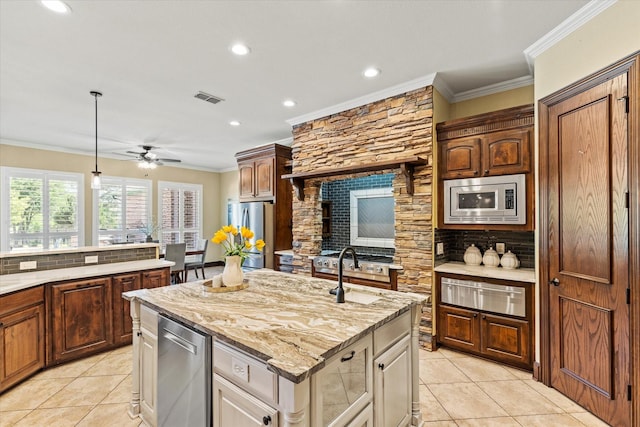 1085 Forest Bend Ct, Cross Roads, TX 76227 - kitchen featuring a warming drawer, appliances with stainless steel finishes, decorative backsplash, light tile patterned floors, and a center island with sink