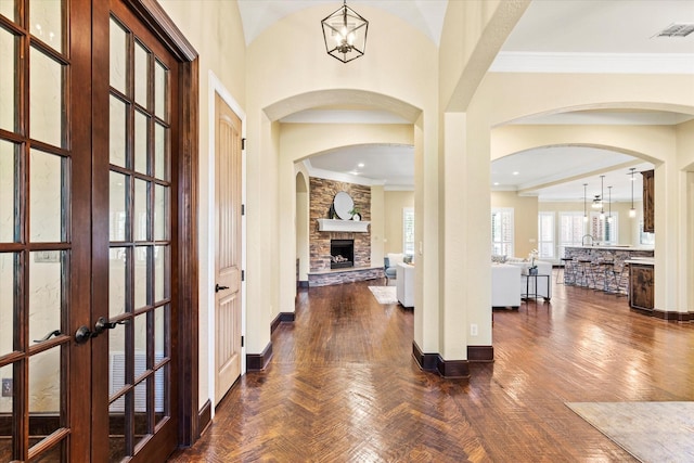1085 Forest Bend Ct, Cross Roads, TX 76227 - entryway featuring a fireplace, arched walkways, baseboards, ornamental molding, and french doors