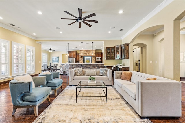 1085 Forest Bend Ct, Cross Roads, TX 76227 - living area with ceiling fan, arched walkways, ornamental molding, wood finished floors, and recessed lighting