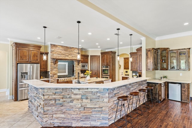 1085 Forest Bend Ct, Cross Roads, TX 76227 - kitchen with stainless steel appliances, a large island with sink, crown molding, backsplash, and recessed lighting