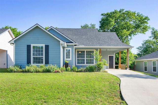 421 E Shepherd St, Denison, TX 75021 - ranch-style house with concrete driveway, a front yard, an attached carport, and a shingled roof