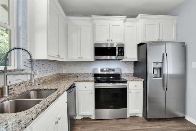 421 E Shepherd St, Denison, TX 75021 - kitchen featuring appliances with stainless steel finishes, a sink, dark wood-style floors, and white cabinets