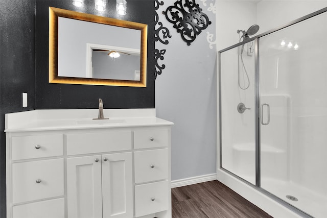 421 E Shepherd St, Denison, TX 75021 - bathroom with a shower stall, wood finished floors, baseboards, and vanity