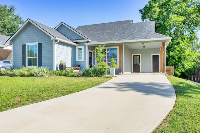 421 E Shepherd St, Denison, TX 75021 - view of front of home with driveway, a carport, and a shingled roof