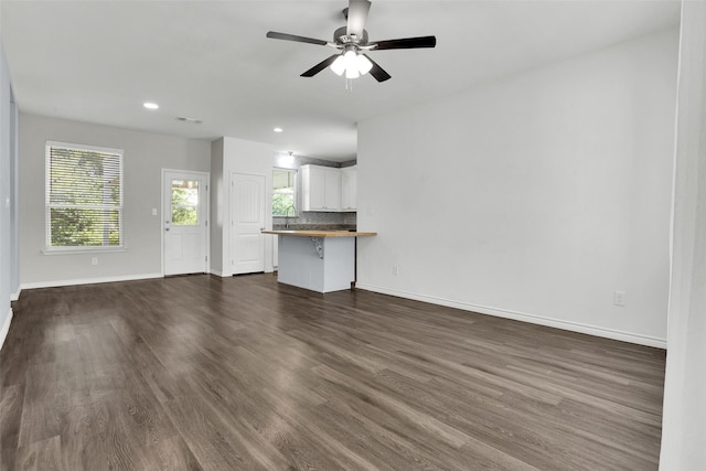 421 E Shepherd St, Denison, TX 75021 - unfurnished living room with dark wood-type flooring, baseboards, ceiling fan, recessed lighting, and a sink