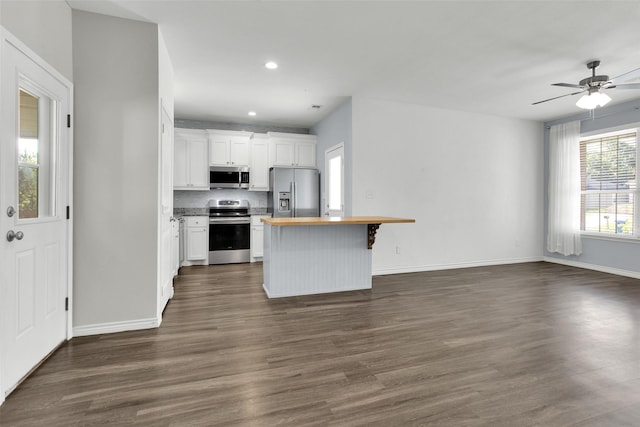 421 E Shepherd St, Denison, TX 75021 - kitchen featuring stainless steel appliances, wooden counters, open floor plan, dark wood-style floors, and recessed lighting