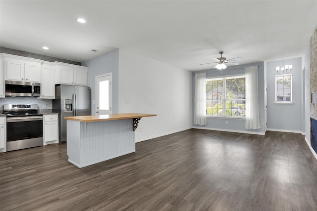 421 E Shepherd St, Denison, TX 75021 - kitchen with appliances with stainless steel finishes, wood counters, white cabinets, dark wood finished floors, and recessed lighting