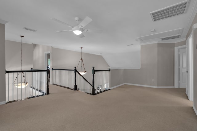 hallway featuring attic access, carpet, baseboards, and lofted ceiling
