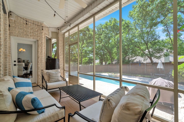 sunroom / solarium with an outdoor living space and a ceiling fan