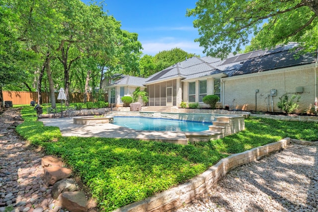 view of pool featuring a sunroom, fence, and a patio