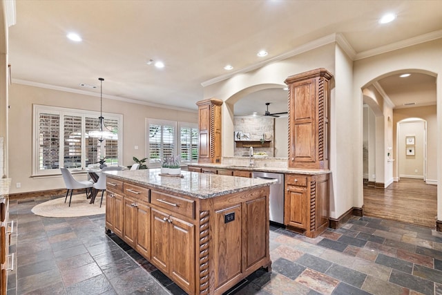 kitchen featuring stainless steel dishwasher, ornamental molding, stone tile floors, baseboards, and brown cabinetry