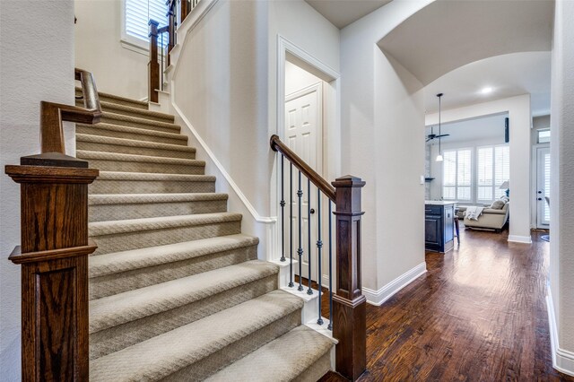 3020 Speyburn, The Colony, TX 75056 - staircase featuring arched walkways, wood finished floors, baseboards, and recessed lighting