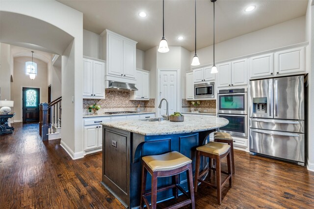 3020 Speyburn, The Colony, TX 75056 - kitchen featuring stainless steel appliances, under cabinet range hood, dark wood-style flooring, white cabinets, and decorative backsplash