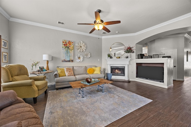 705 Eagle Ct, Mansfield, TX 76063 - living area with ceiling fan, arched walkways, wood finished floors, crown molding, and a warm lit fireplace
