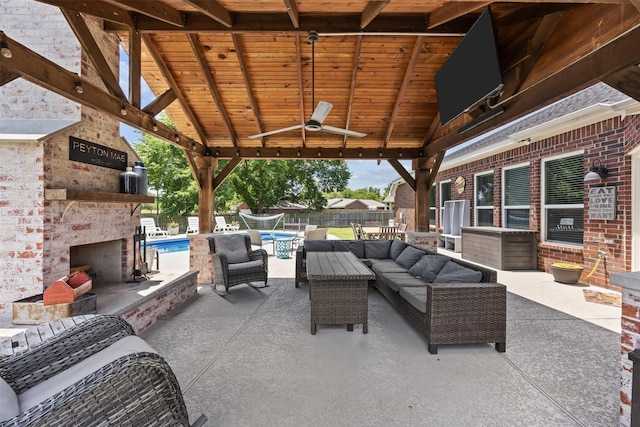705 Eagle Ct, Mansfield, TX 76063 - view of patio featuring an outdoor living space with a fireplace, ceiling fan, fence, and a gazebo