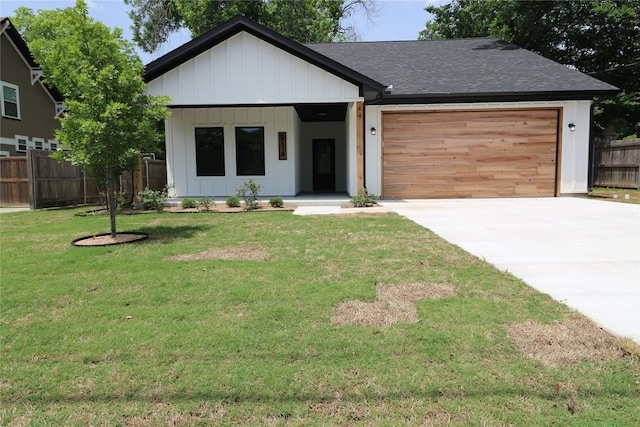 914 S Brazos St, Weatherford, TX 76086 - view of front of house with an attached garage, concrete driveway, board and batten siding, and a shingled roof