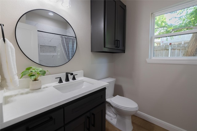 914 S Brazos St, Weatherford, TX 76086 - bathroom with toilet, vanity, baseboards, wood finished floors, and a shower with shower curtain