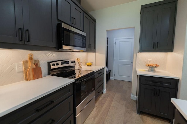 914 S Brazos St, Weatherford, TX 76086 - kitchen featuring stainless steel appliances, light wood finished floors, light countertops, and tasteful backsplash