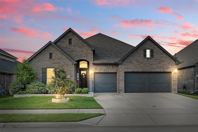 1105 Collared Dove Dr, Little Elm, TX 75068 - french country home featuring brick siding, concrete driveway, a yard, and a garage