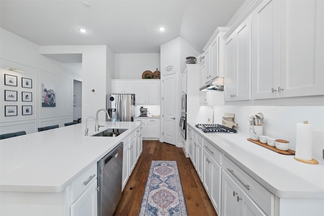 1105 Collared Dove Dr, Little Elm, TX 75068 - kitchen with stainless steel appliances, a sink, a kitchen island with sink, white cabinetry, and recessed lighting