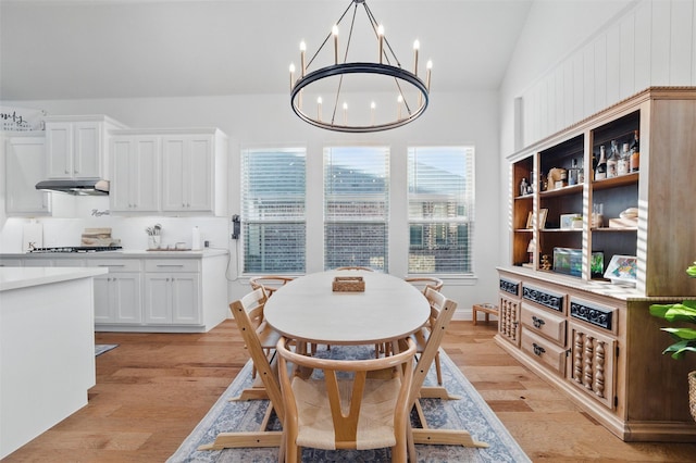 1105 Collared Dove Dr, Little Elm, TX 75068 - dining space with a chandelier, vaulted ceiling, and light wood-type flooring