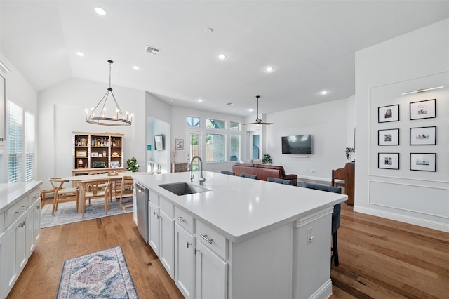 1105 Collared Dove Dr, Little Elm, TX 75068 - kitchen featuring a sink, a chandelier, light wood finished floors, white cabinetry, and light countertops